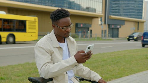 Man Wearing Eyeglasses Using a Cellphone