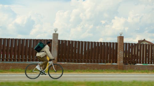 Man Carrying Thermal Bag Riding a Bike