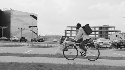 Person Carrying Thermal Bag Riding a Bike