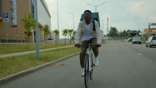 Delivery Man Cycling on the Road