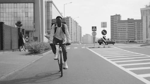 Delivery Man Cycling on the Street