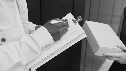 Close Up Video of a Person Writing on a Paper