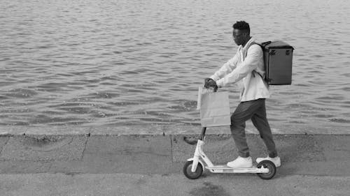 Delivery Man Riding a Scooter