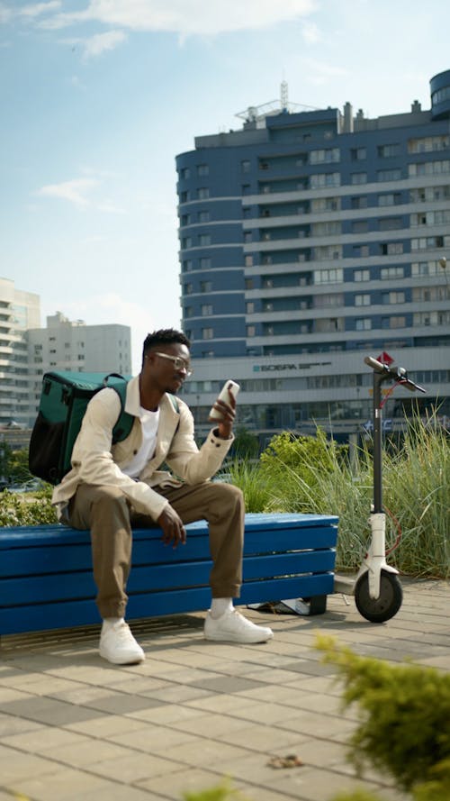 A Delivery Man Sitting on a Bench 