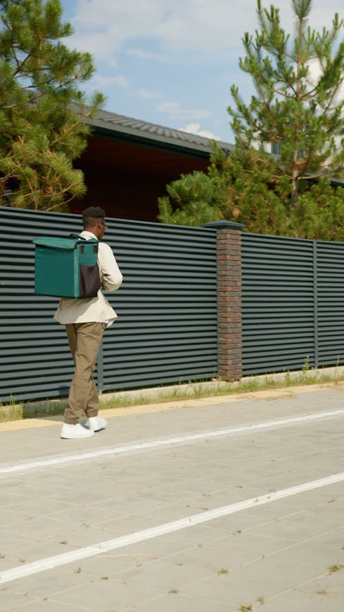 A Man Walking with a Delivery Bag
