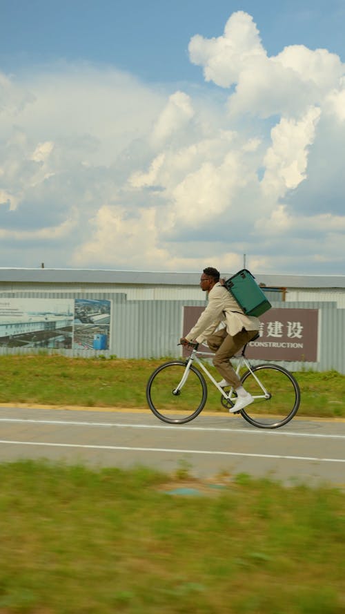 A Delivery Man Riding his Bike
