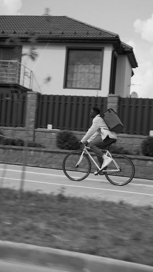 A Delivery Man Riding His Bike 