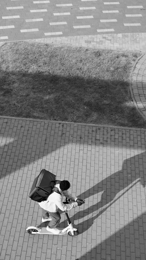 Man Riding a Scooter