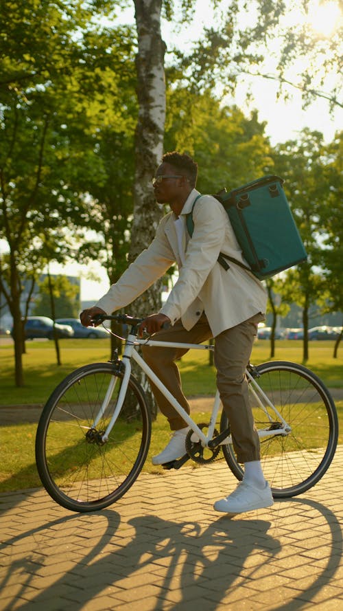 Man Carrying Thermal Bag Riding a Bike