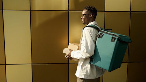 A Delivery Man Holding Food Takeout Boxes