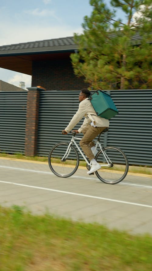 A Delivery Man Riding his Bicycle while Crossing the Pedestrian 