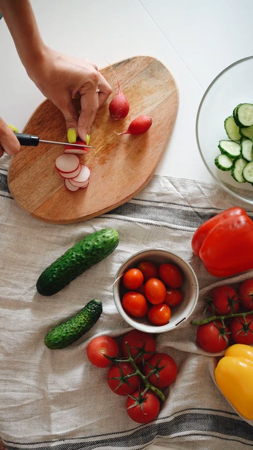 High Angle Shot of a Person Slicing Radish