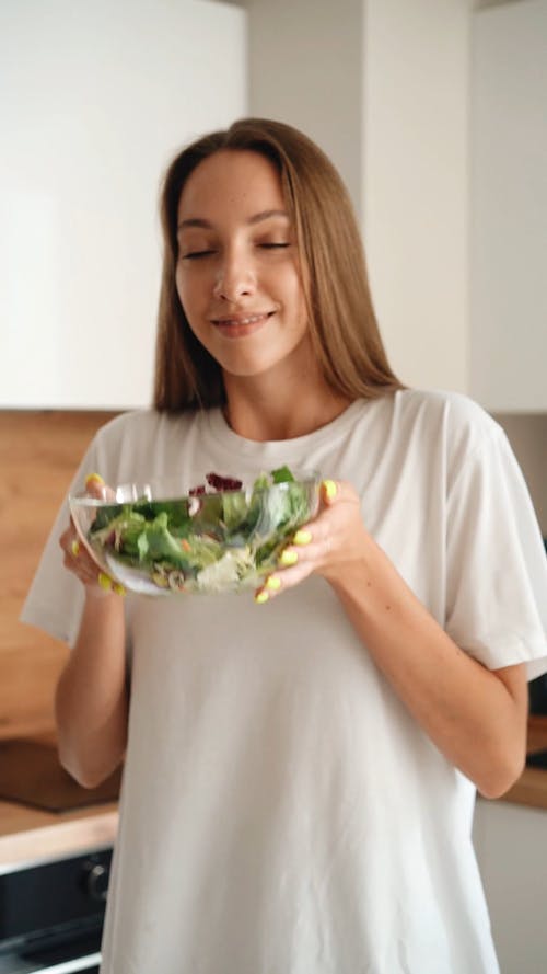 A Woman Holding a Bowl of Vegetables