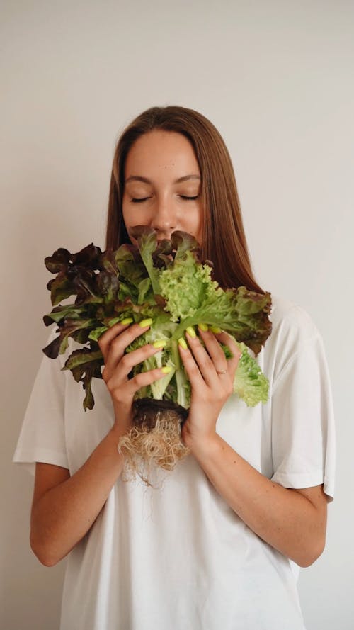 Woman Smelling Fresh Vegetables