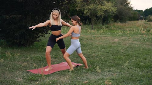 Woman Doing Yoga with Instructor
