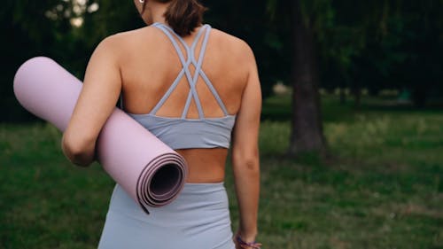 A Woman Carrying a Yoga Mat 