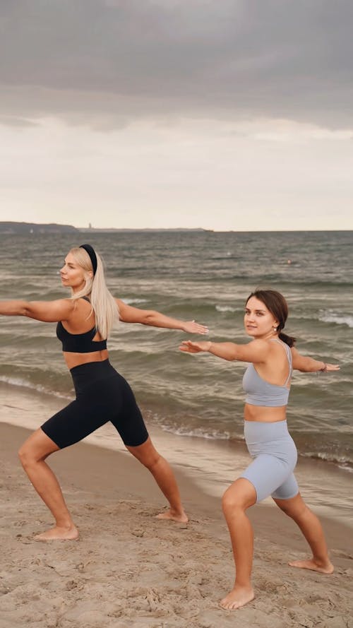 Women Doing Yoga at the Beach
