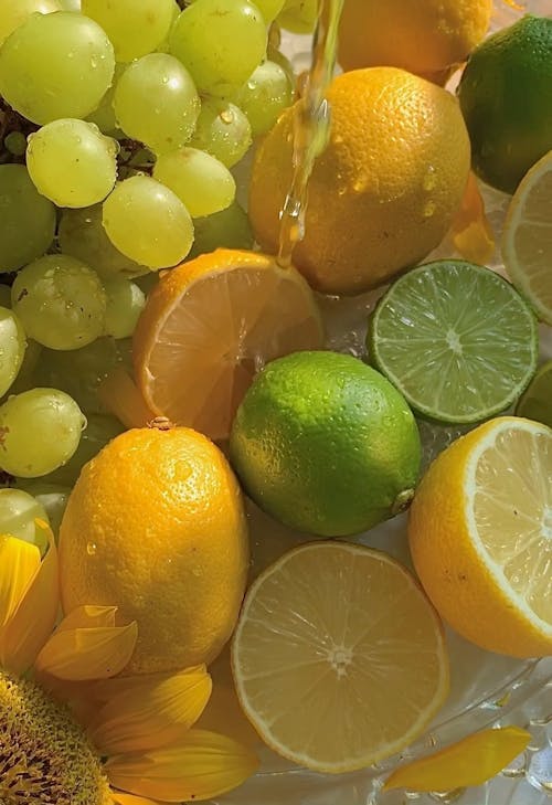 A Person Pouring Water on Fresh Fruits