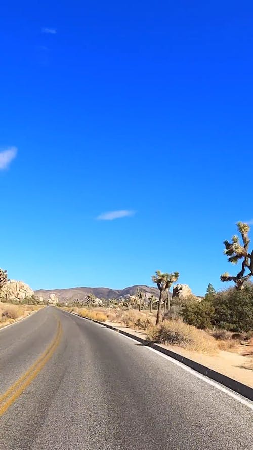 Hyperlapse Footage of a Car Passing on a Road in the Desert