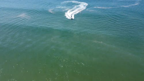 A Drone Footage of a Person Riding a Motorboat