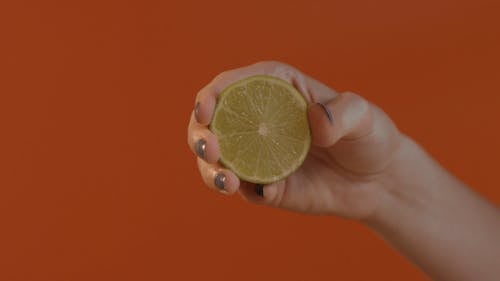 A Person Squeezing a Lemon