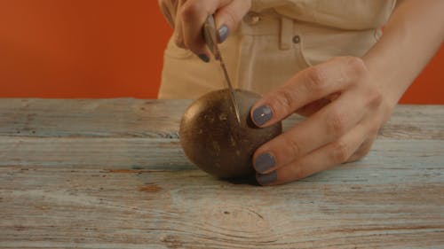 A Person Cutting a Passion Fruit 