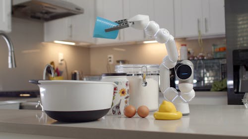 A Clicbot Pouring Sugar into a Mixing Bowl