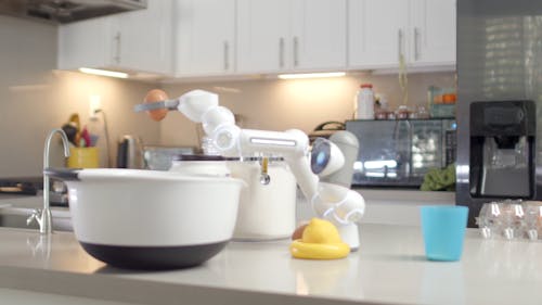 A ClicBot Dropping an Egg in a Mixing Bowl