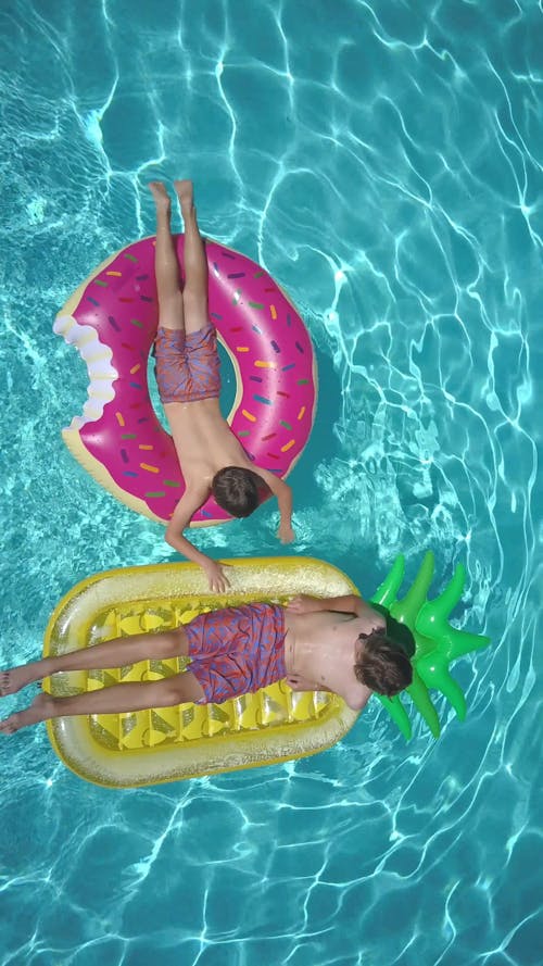 Birds Eye View of Men Using Floaters in a Swimming Pool