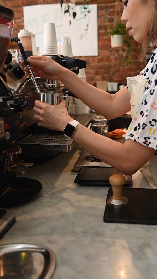 A Woman Preparing a Coffee