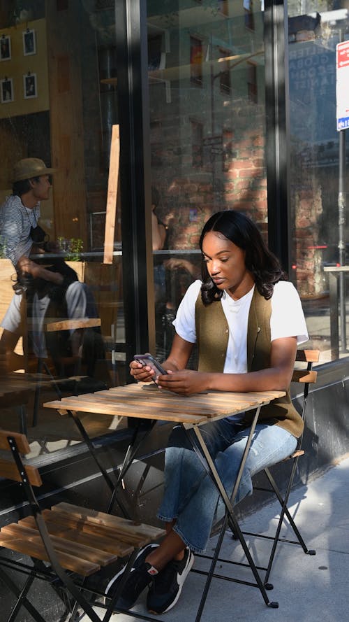 A Man and Woman Drinking Coffee Outside the Café