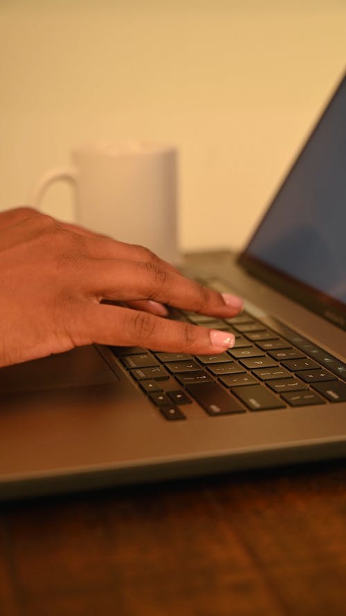 A Person Typing on Laptop Keyboard