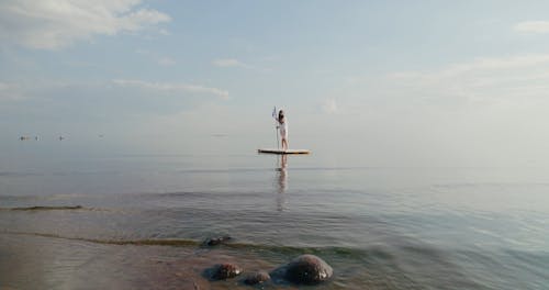 A Woman Standing on the Raft