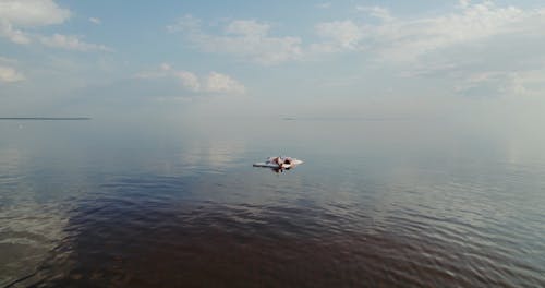 Aerial Shot of Women Lying on a Raft