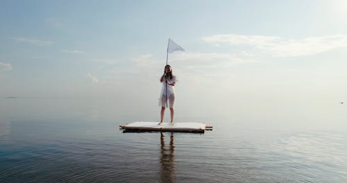 A Woman Standing on a Raft
