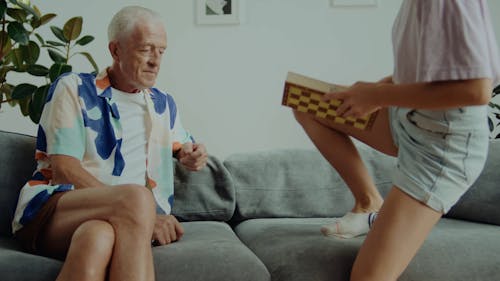 Granddaughter Showing Chess to His Grandfather