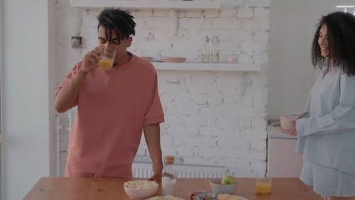 A Couple Preparing Breakfast on a Bowl