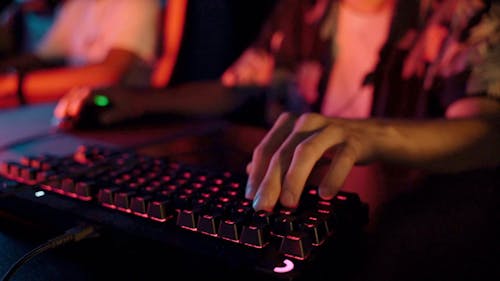 Close up Shot of a Man Using a Gaming Keyboard