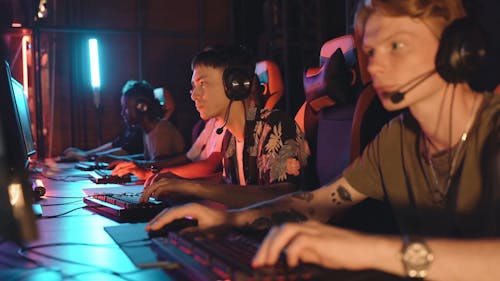 Men Wearing Headset While Playing Computer Games