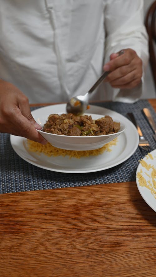 Person Putting Food on Plate