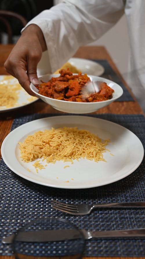 Person Putting Food on Plate