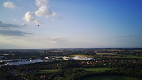 A Drone Footage of a Flying Hot Air Balloon in the Sky