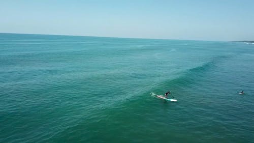 Surfers Surfing on Waves