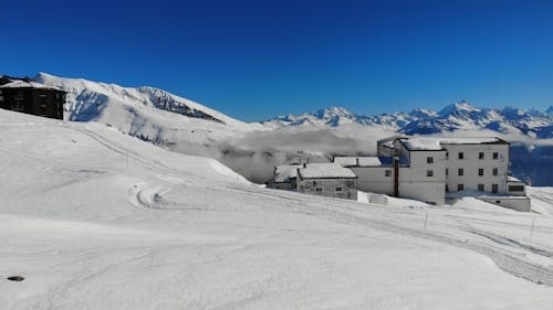 A Footage of Houses and Mountains Covered With Snow