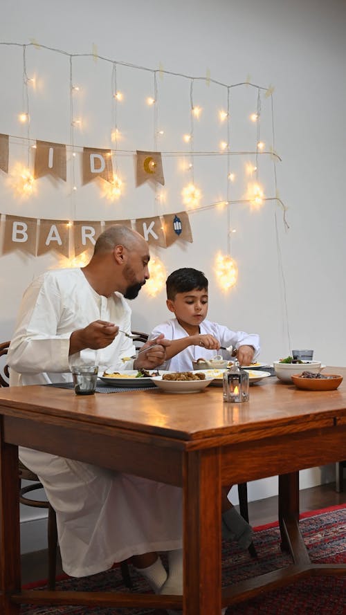 Father and Son Eating Together