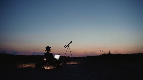 A Man Using His Laptop on a Camping Site
