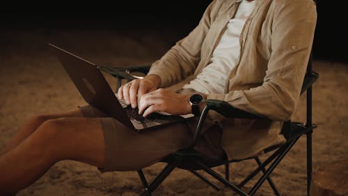 Close up Shot of a Man Using his Laptop Outdoors