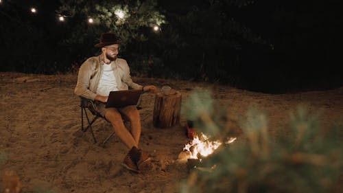 A Man Drinking Coffee while using Laptop