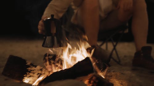 A Man Pouring Coffee in a Cup