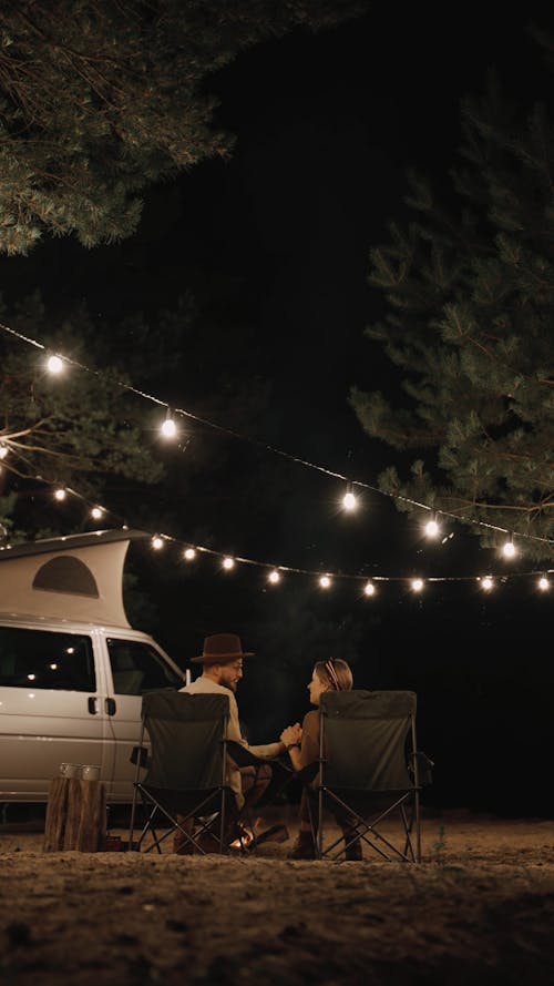 Couple Talking and Kissing while on Camping Site